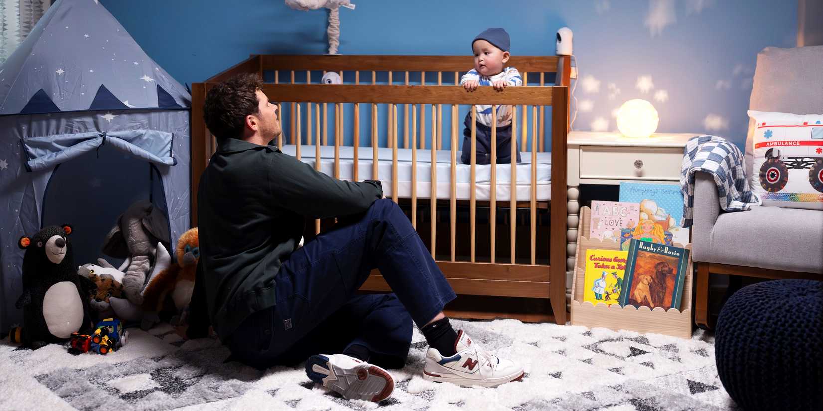 Oliver Stark as Buck talking with Baby Bobby in his crib in the 9-1-1 season 9 premiere