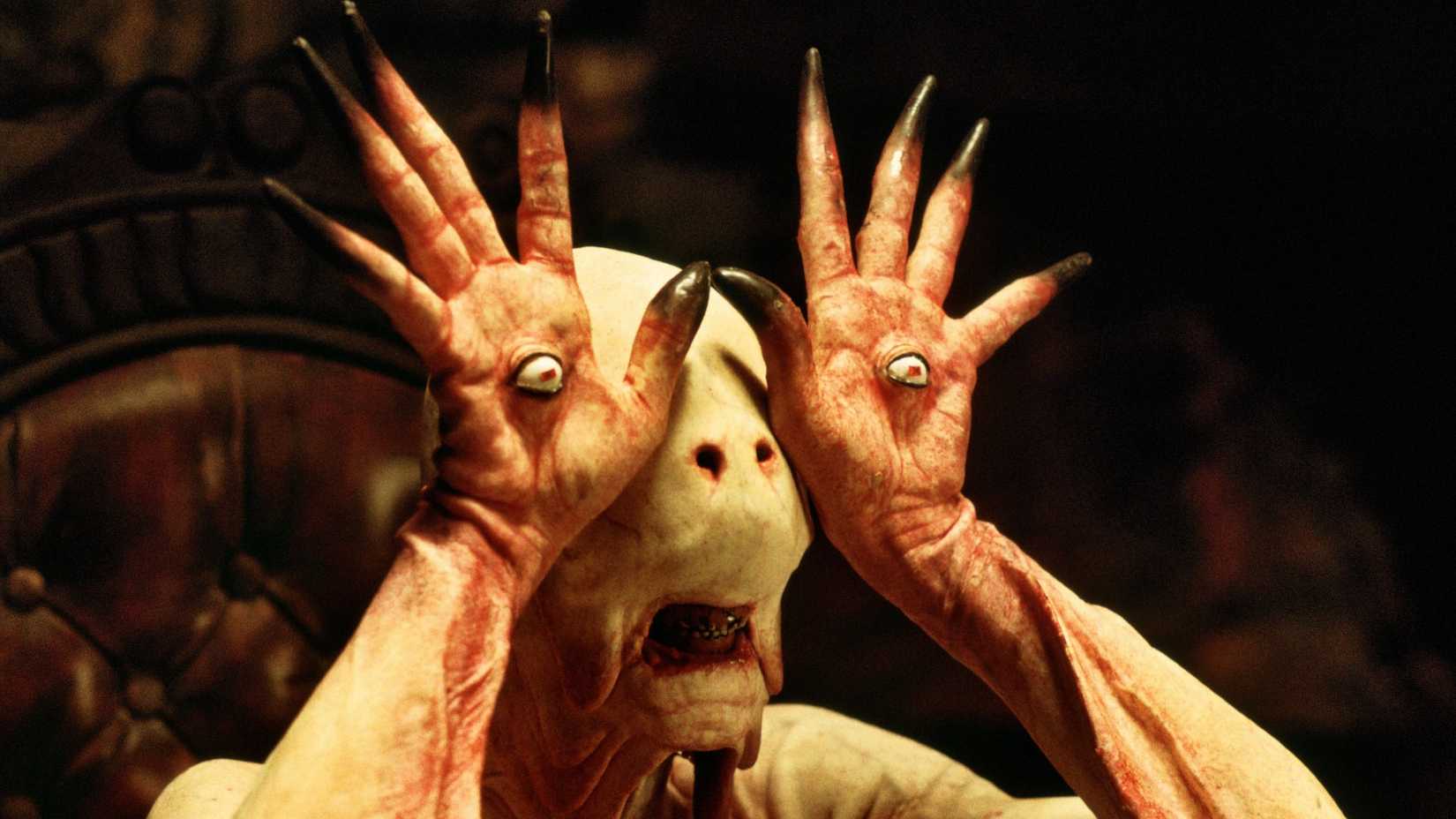 The pale man holds up his hands with eyeballs in his palms in Pan's Labyrinth