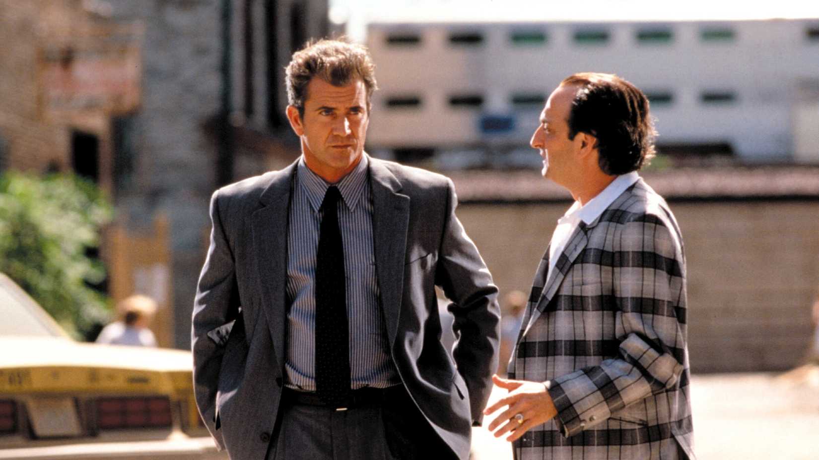 Mel Gibson talks to a man looking angry in Payback