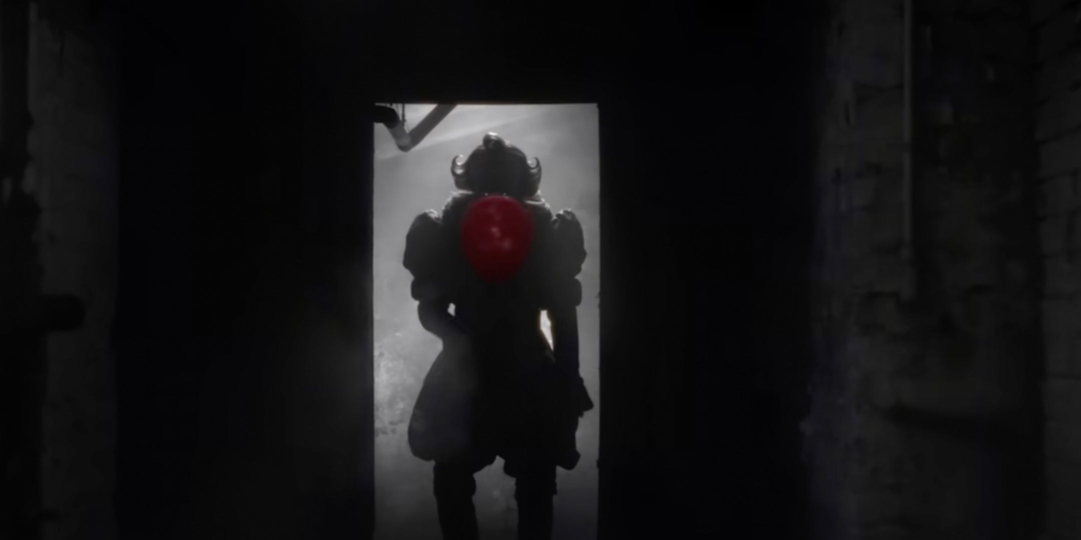 Pennywise holds up a red balloon in the sewers from It Welcome to Derry trailer