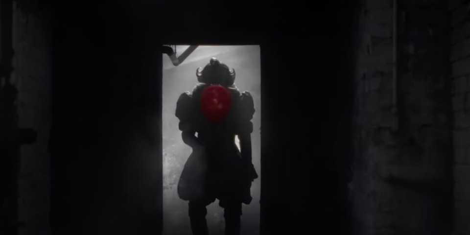 Pennywise holds up a red balloon in the sewers from It Welcome to Derry trailer