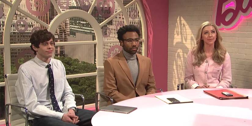 Peter Davidson, Donald Glover, and Heidi Gardner sitting at a desk at the Barbie corp. in Barbie Instagram in SNL.