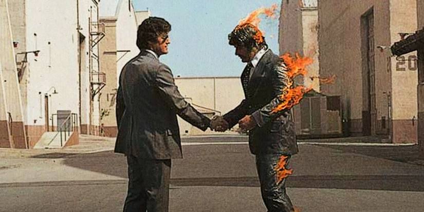 The album art for Pink Floyd's Wish You Were Here, showing two men shaking hands. One man is on fire.