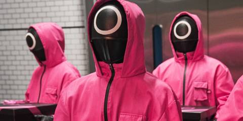 Pink-hooded guards carrying boxes in Squid Game season 3