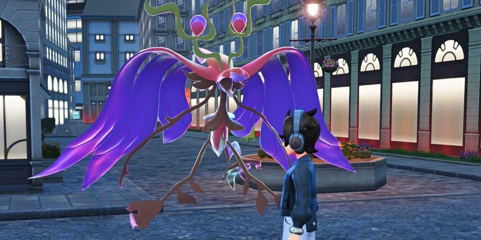 A Trainer stands next to its Mega Dragalge in Lumiose City in Pokemon Legends Z-A.