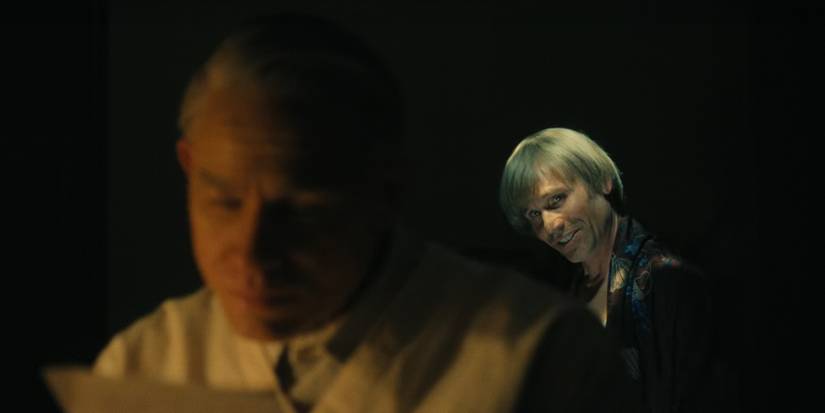 Richard Speck is behind Ed Gein as he reads a letter in Monster The Ed Gein Story