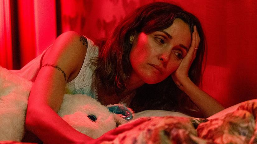 Rose Byrne's Linda laying down and looking tiredly at her daughter in If I Had Legs, I'd Kick You