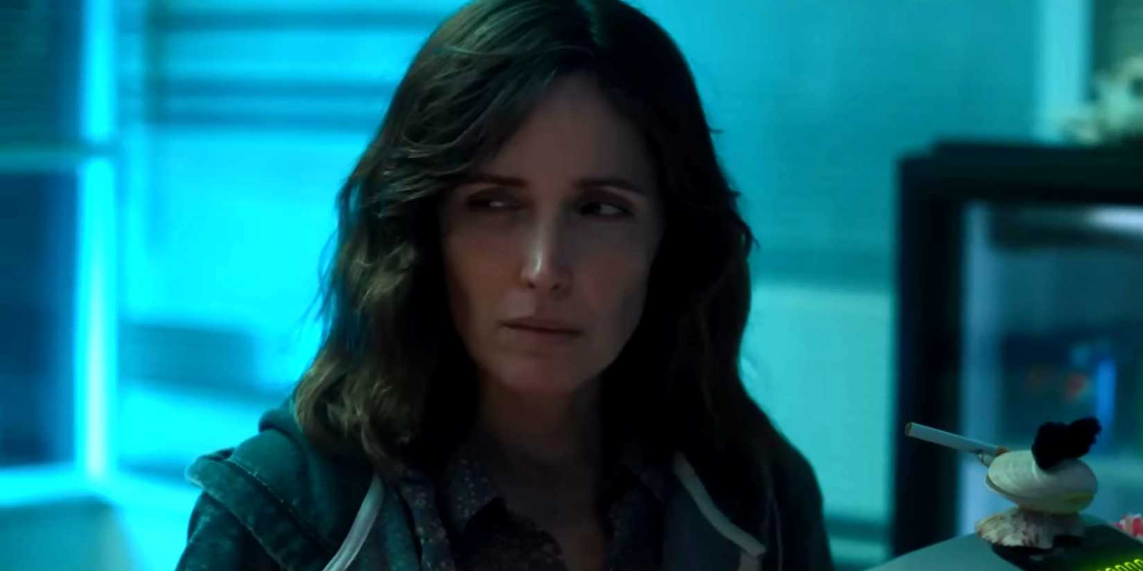 Rose Byrne's Linda looking suspiciously while standing in the motel lobby in If I Had Legs, I'd Kick You