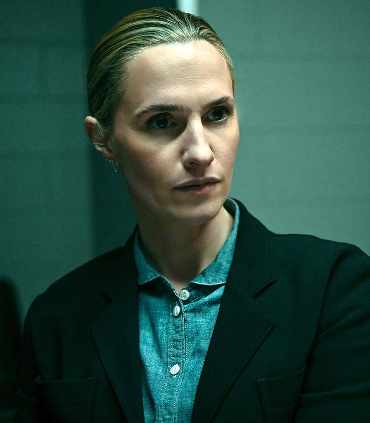 Ruth Bradley's Emma Flyte looking seriously at someone while sitting down in Slow Horses season 5