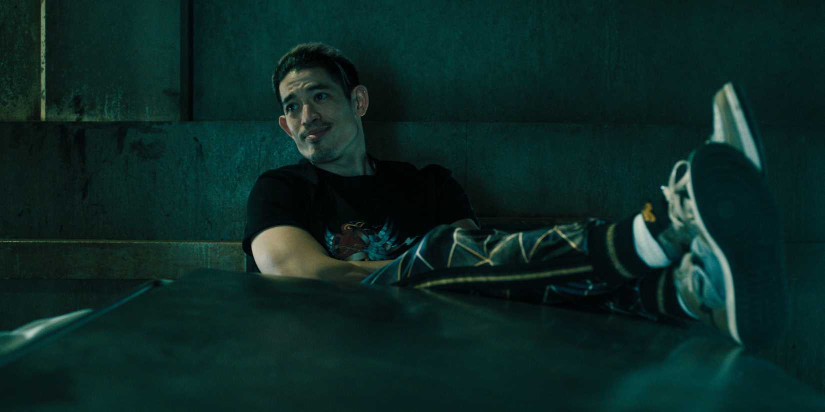 Roddy Ho (Christopher Chung) leaning back during an interrogation in Slow Horses season 5, episode 3.