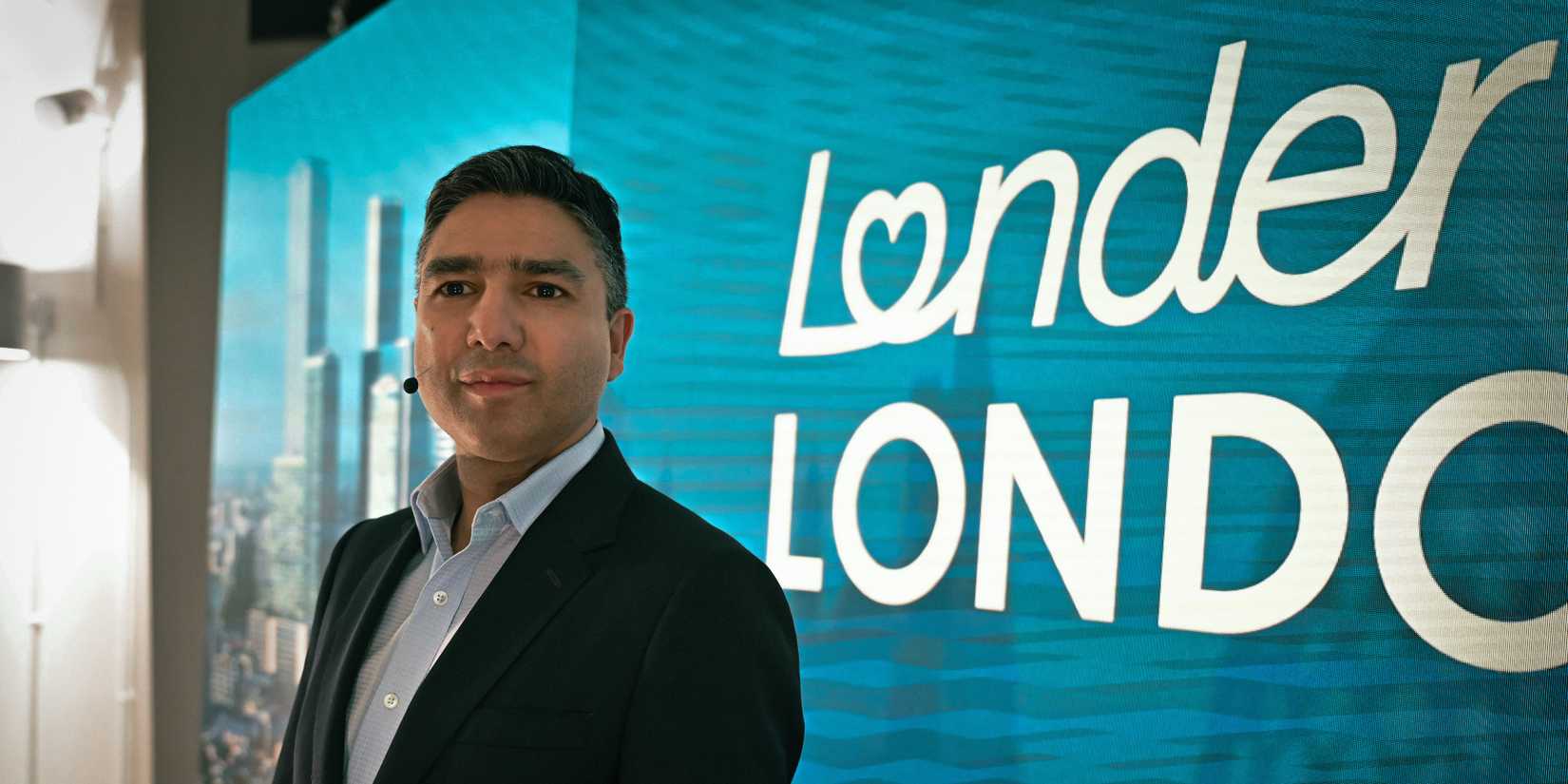 Zafar Jaffrey (Nick Mohammed) smiling in front of his campaigns logo in Slow Horses season 5, episode 4.