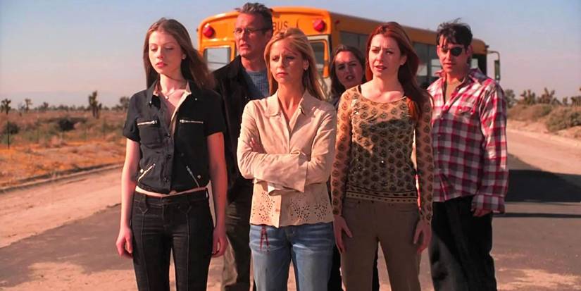The Buffy the Vampire Slayer cast standing together in front of a school bus for one last time