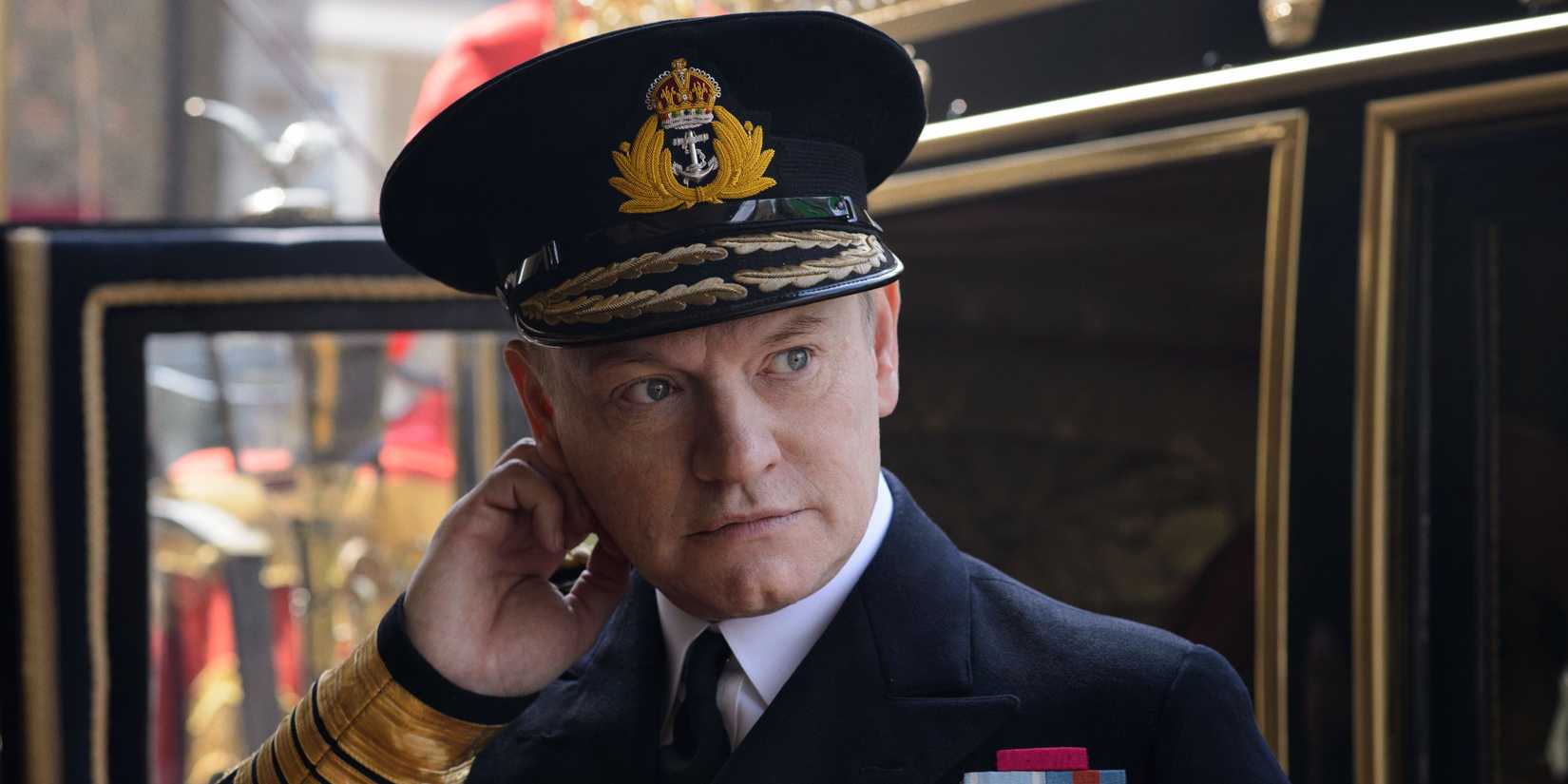 King George VI (Jared Harris) scratching his ear in The Crown.