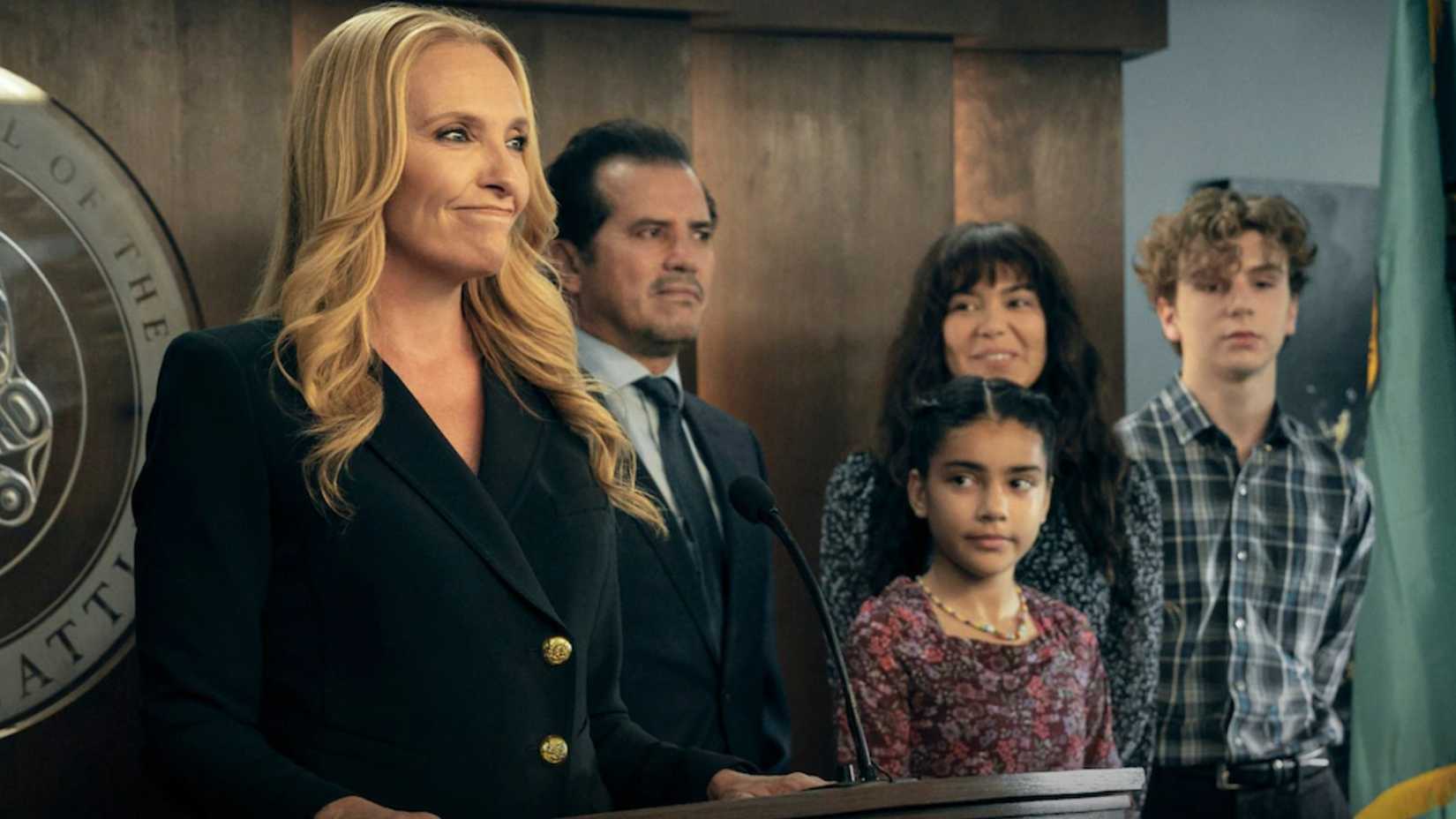 Toni Collette standing at a desk among other characters from The Power on Prime Video
