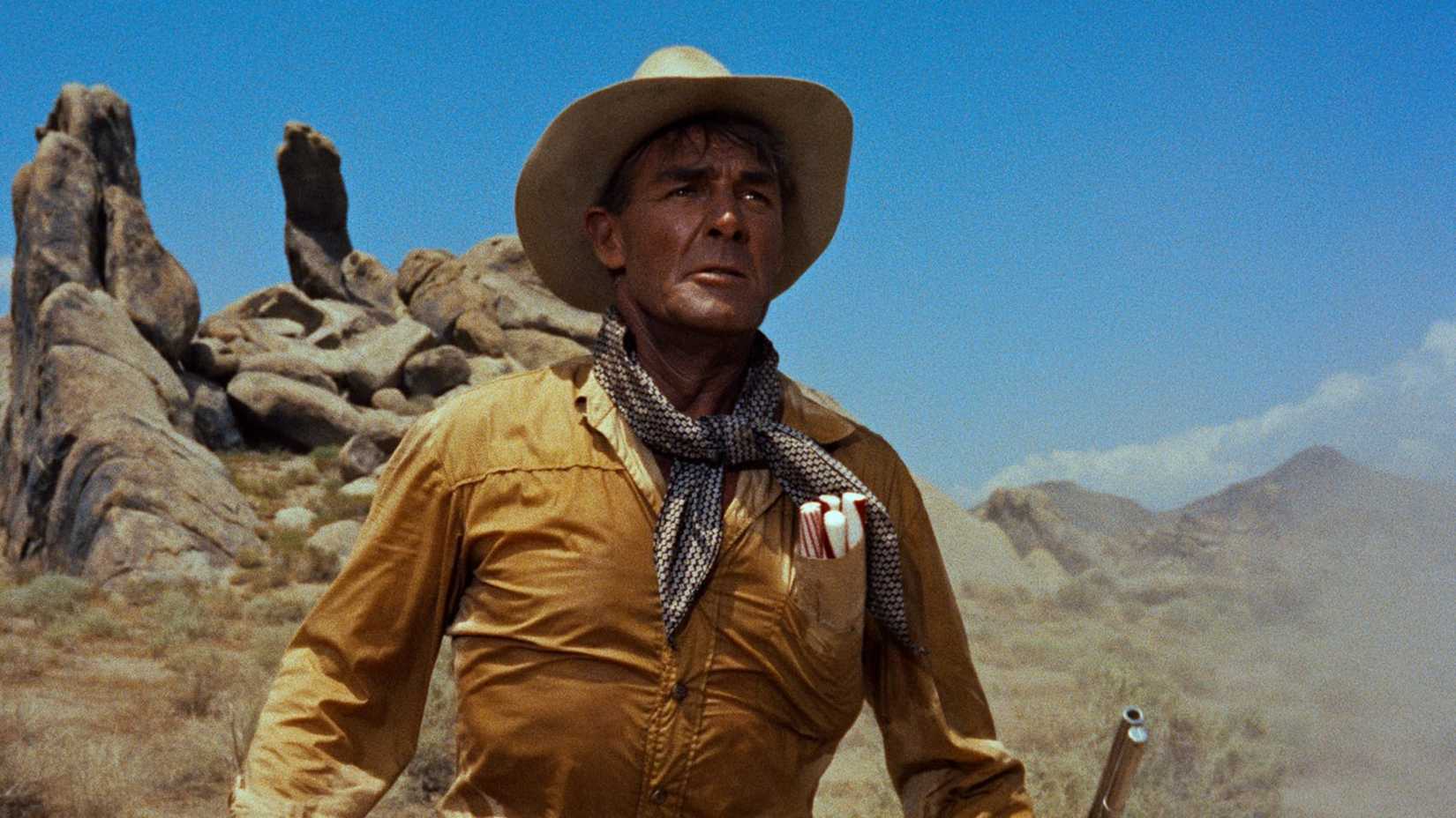 Randolph Scott looks on dramatically against a desert landscape in The Tall T