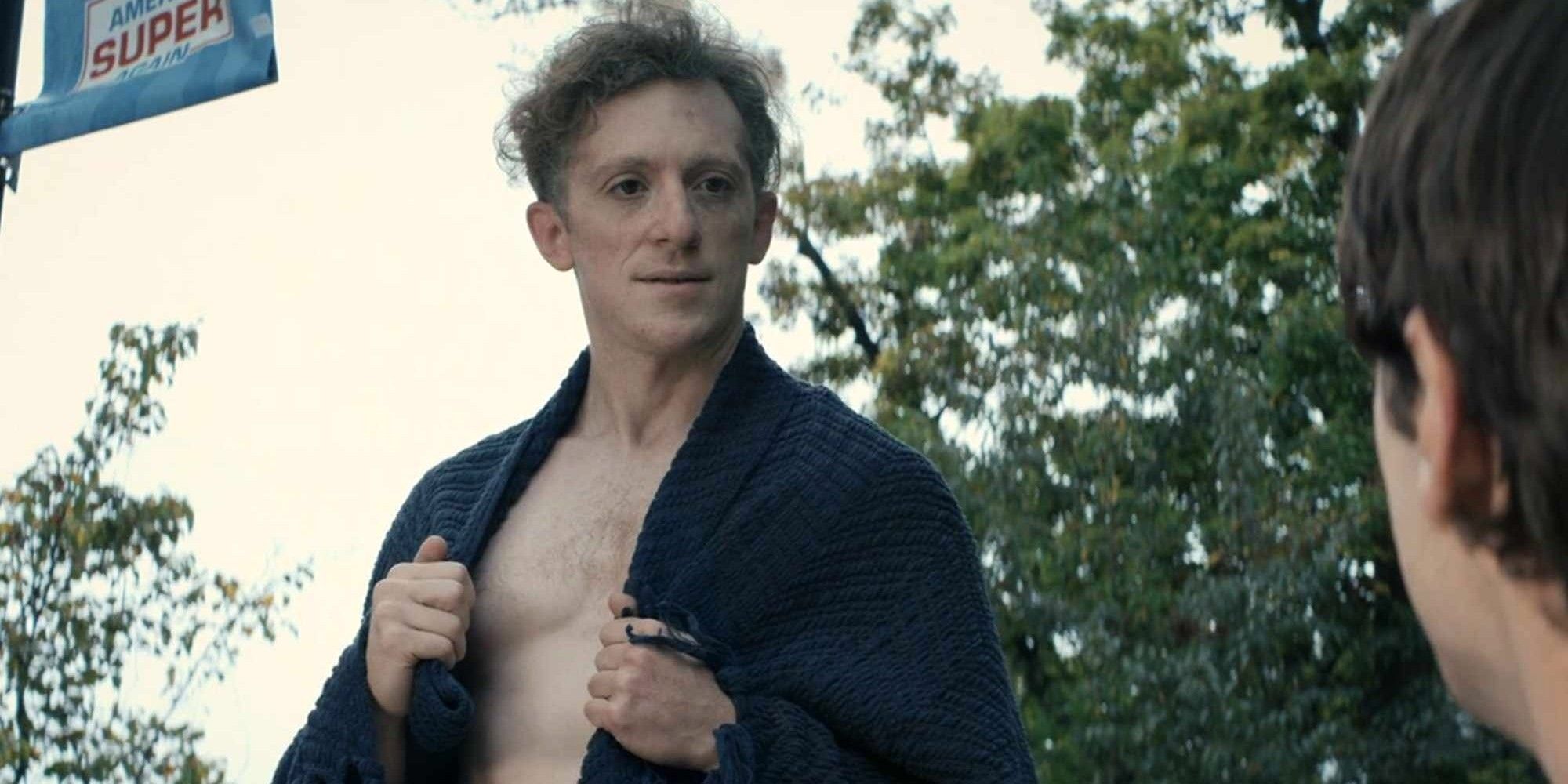 Thomas Godolkin wearing a bathrobe and looking down at someone In Gen V Season 2