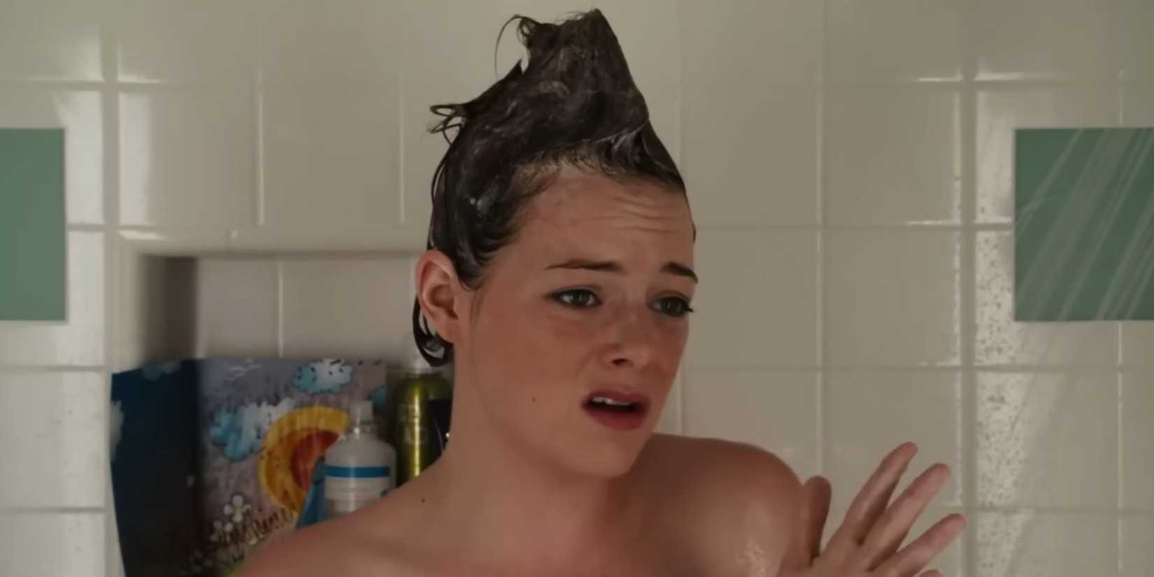 Emma Stone as Olive, who has a soapy mohawk, singing in the shower in Easy A.
