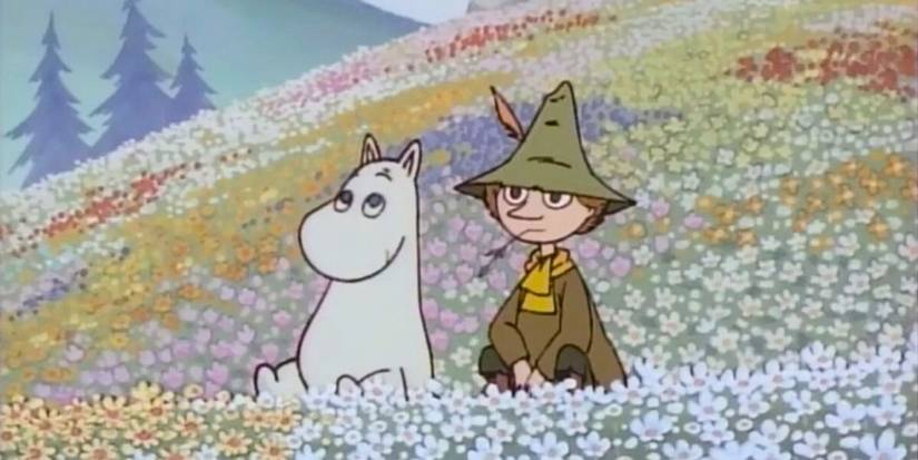 A moomin and a friend sitting in a meadow of flowers