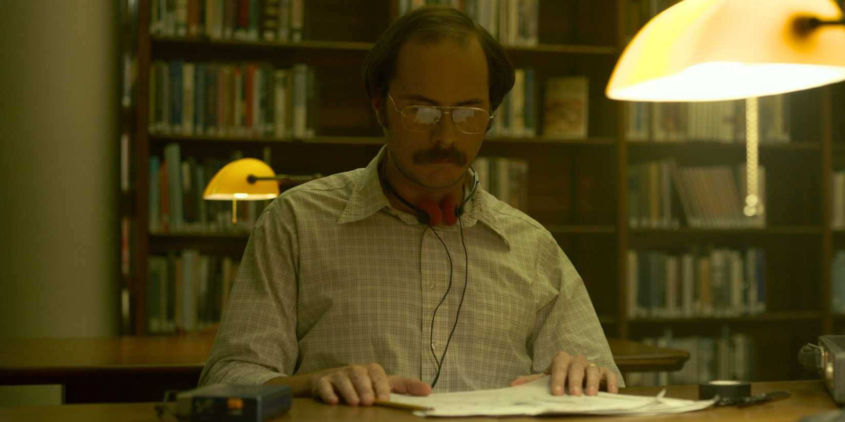 Dennis Rader aka BTK sitting at a desk and looking at papers