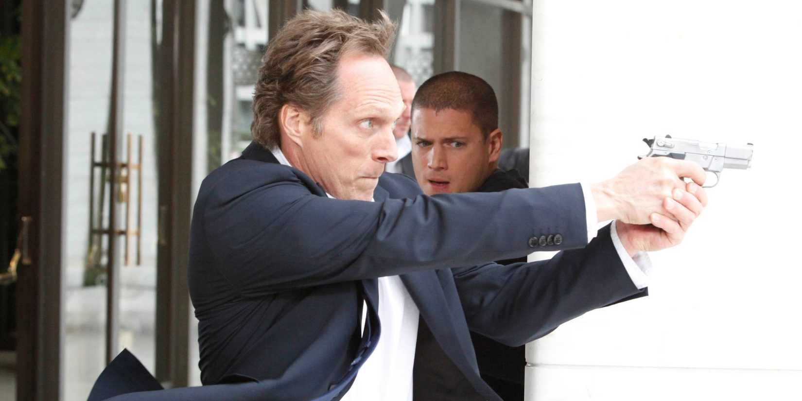 Mahone shoots a gun while Michael looks horrified in the background