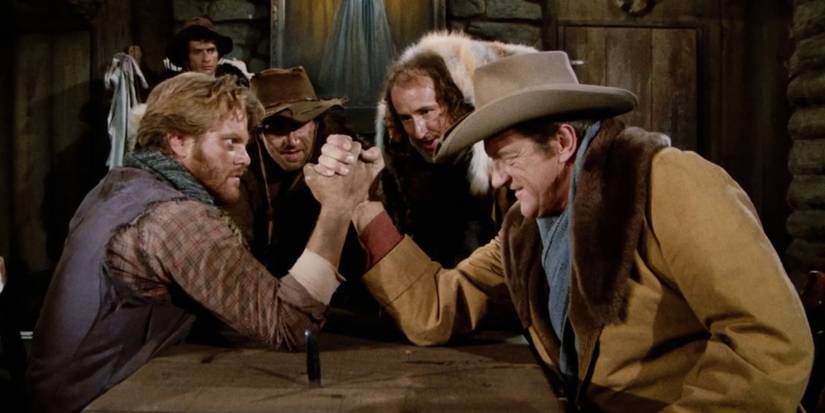 Dois personagens disputam queda de braço em Gunsmoke