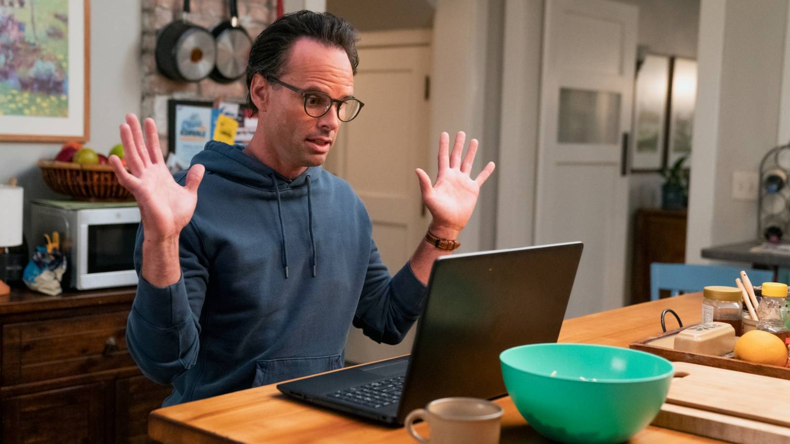 Wade (Walton Goggins) with his hands up, staring at a laptop in surprise in The Unicorn