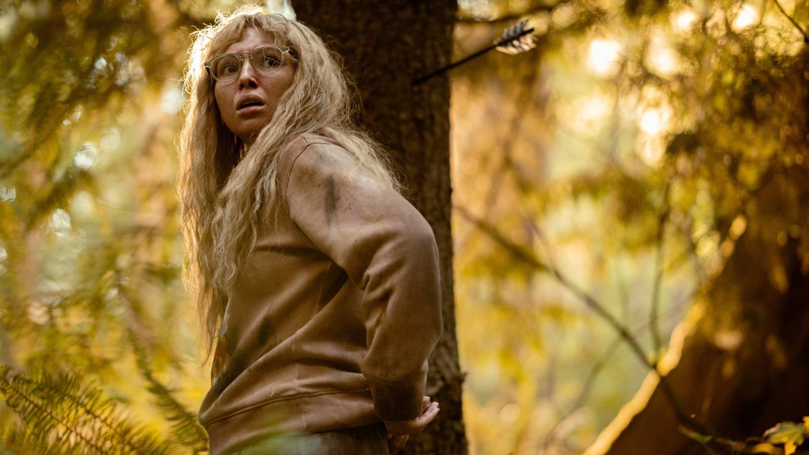 A teenage Misty Quigley (Samantha Hanratt) looking terrified in the woods in Yellowjackts