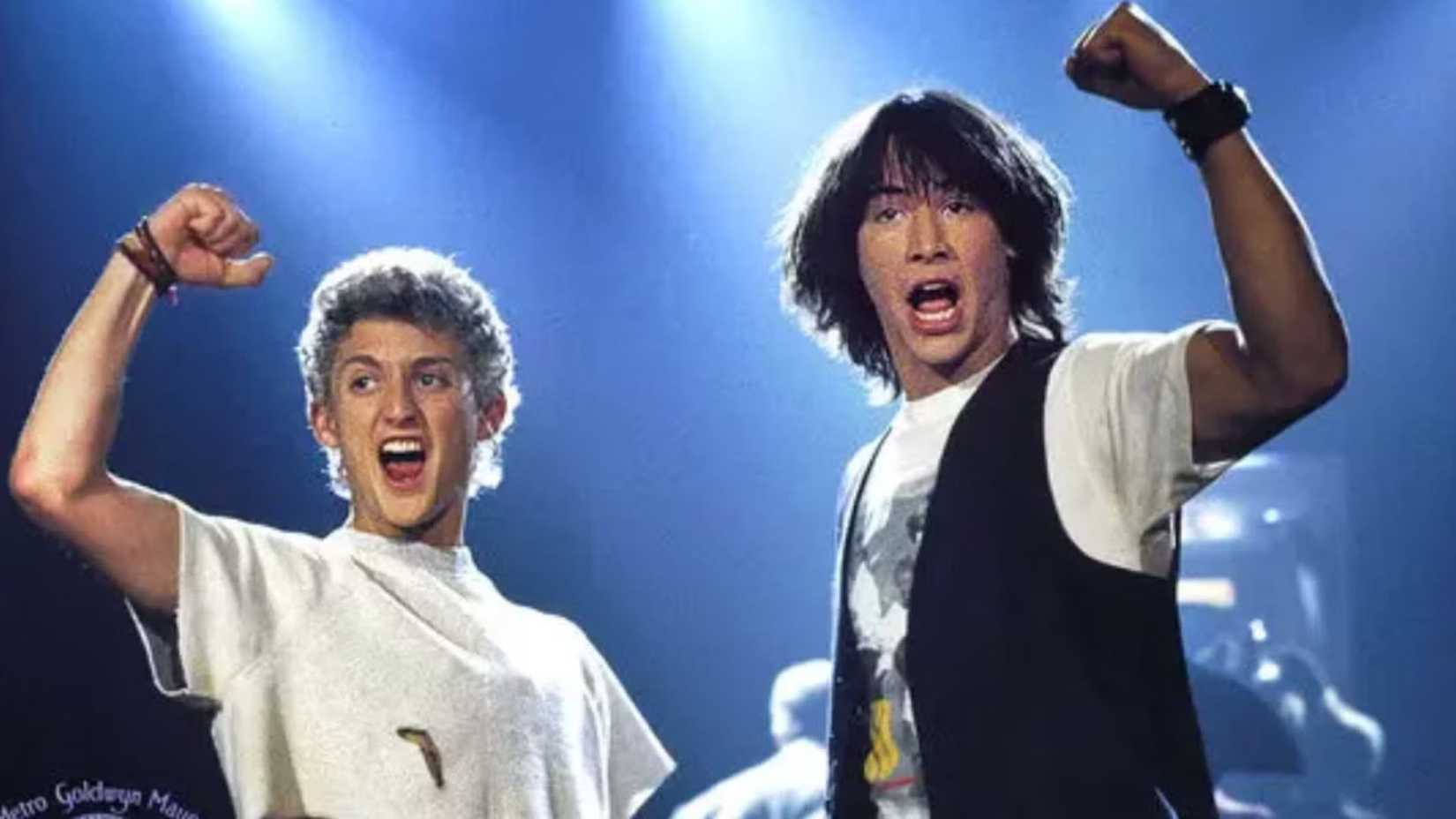 Alex Winter as Bill and Keanu Reeves as Ted on stage and cheering in Bill & Ted's Excellent Adventure