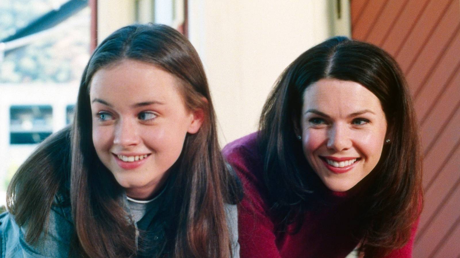 Alexis Bledel's Rory and Lauren Graham's Lorelei look in a window in Gilmore Girls