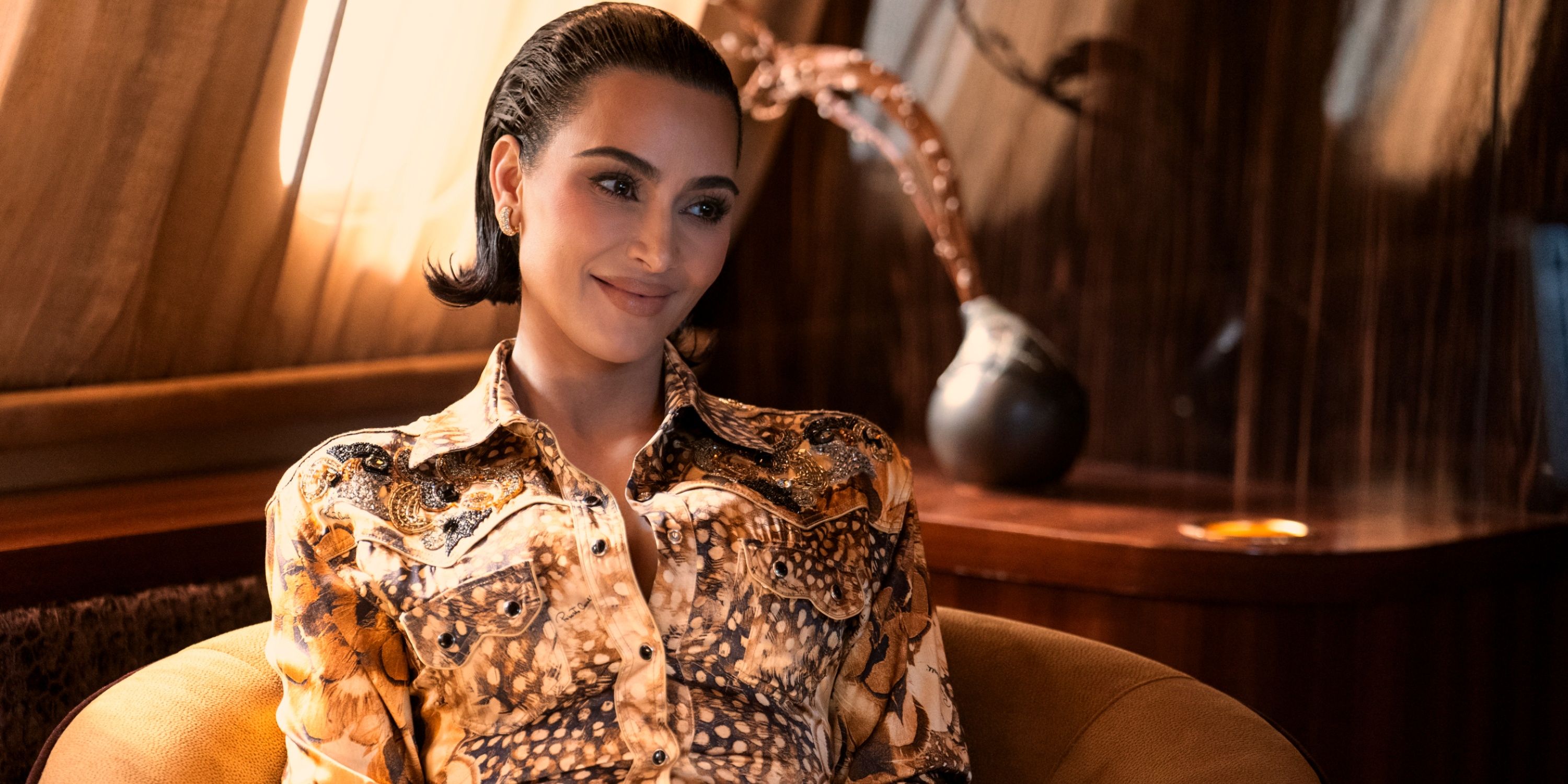 Allra Grant (Kim Kardashian) smiling on a private plane in All's Fair