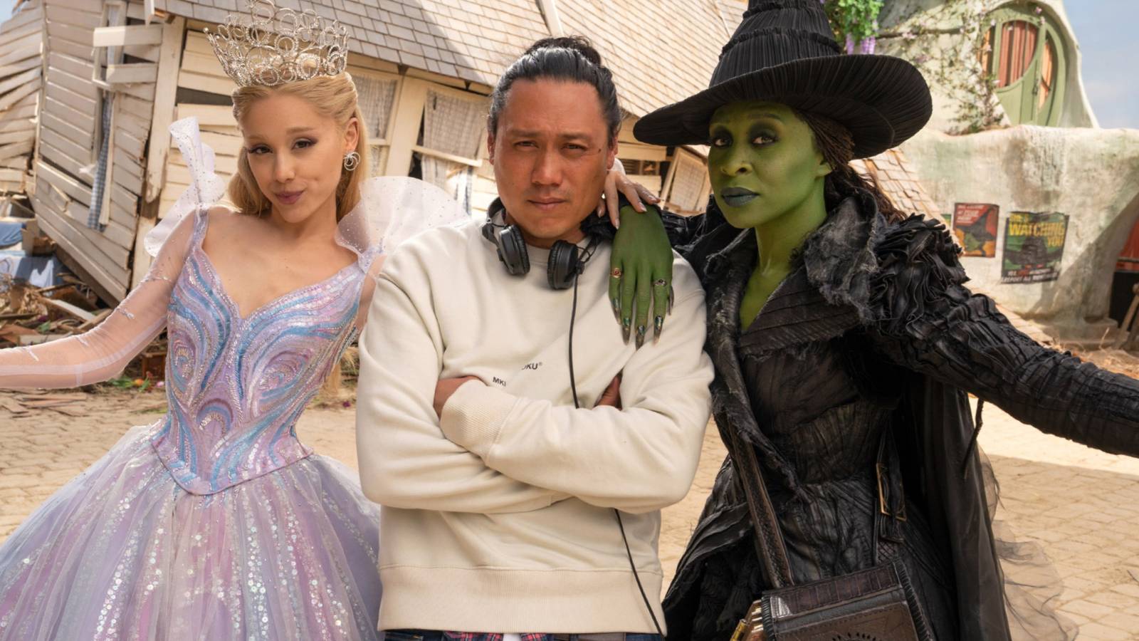Ariana Grande and Cynthia Erivo posing with Jon M Chu on the set of Wicked For Good