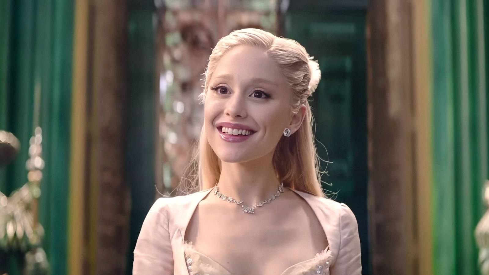 Ariana Grande as Glinda smiling widely in Wicked For Good