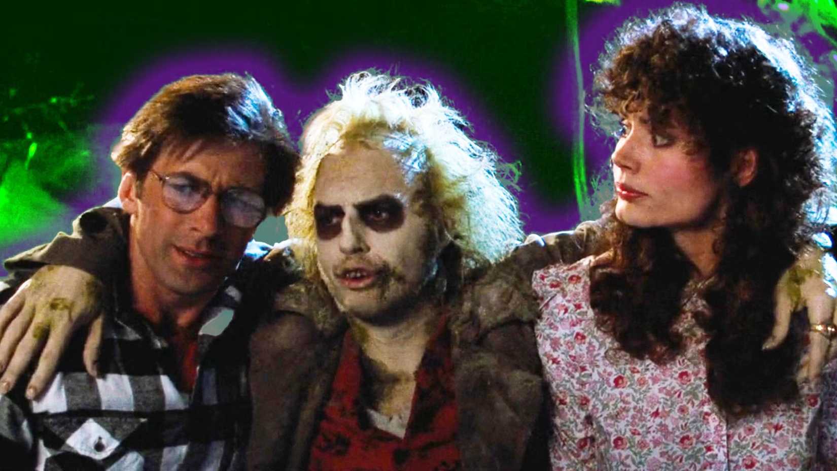Beetlejuice (Michael Keaton) with his arms around a worried Adam (Alec Baldwin) and Barbara Maitland (Geena Davis) in Beetlejuice