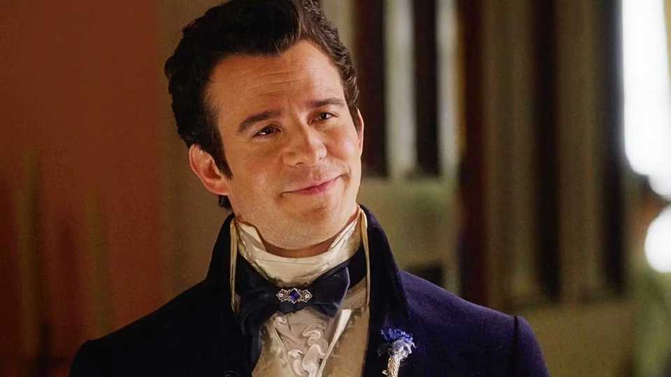 Benedict looking fondly at Eloise, who is out of frame, at Colin and Penelope's reception in Bridgerton season 3