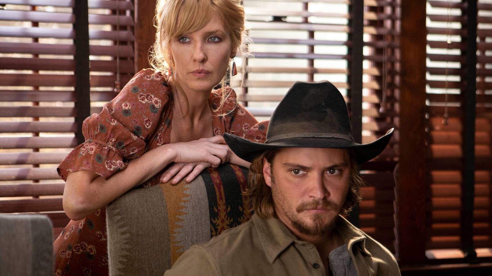 Beth and Kayce, with Beth standing behind her brother, in a promo shot for Yellowstone