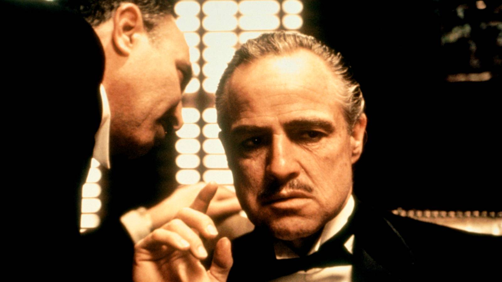 Bonasera whispering to Don Corleone in The Godfather