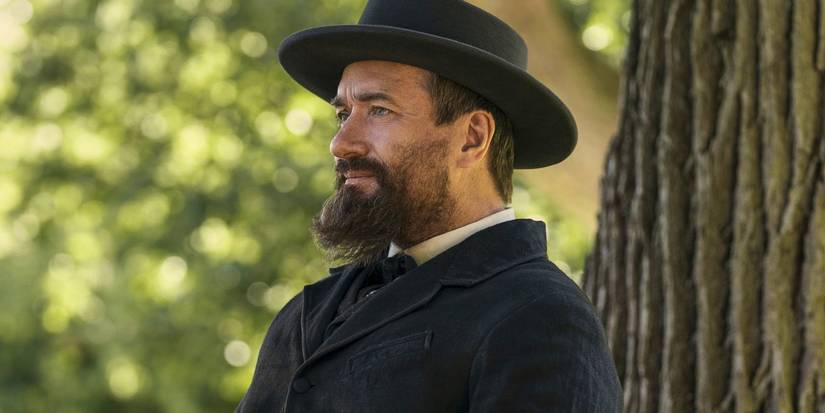 Charles Guiteau sits by a tree in Death by Lightning