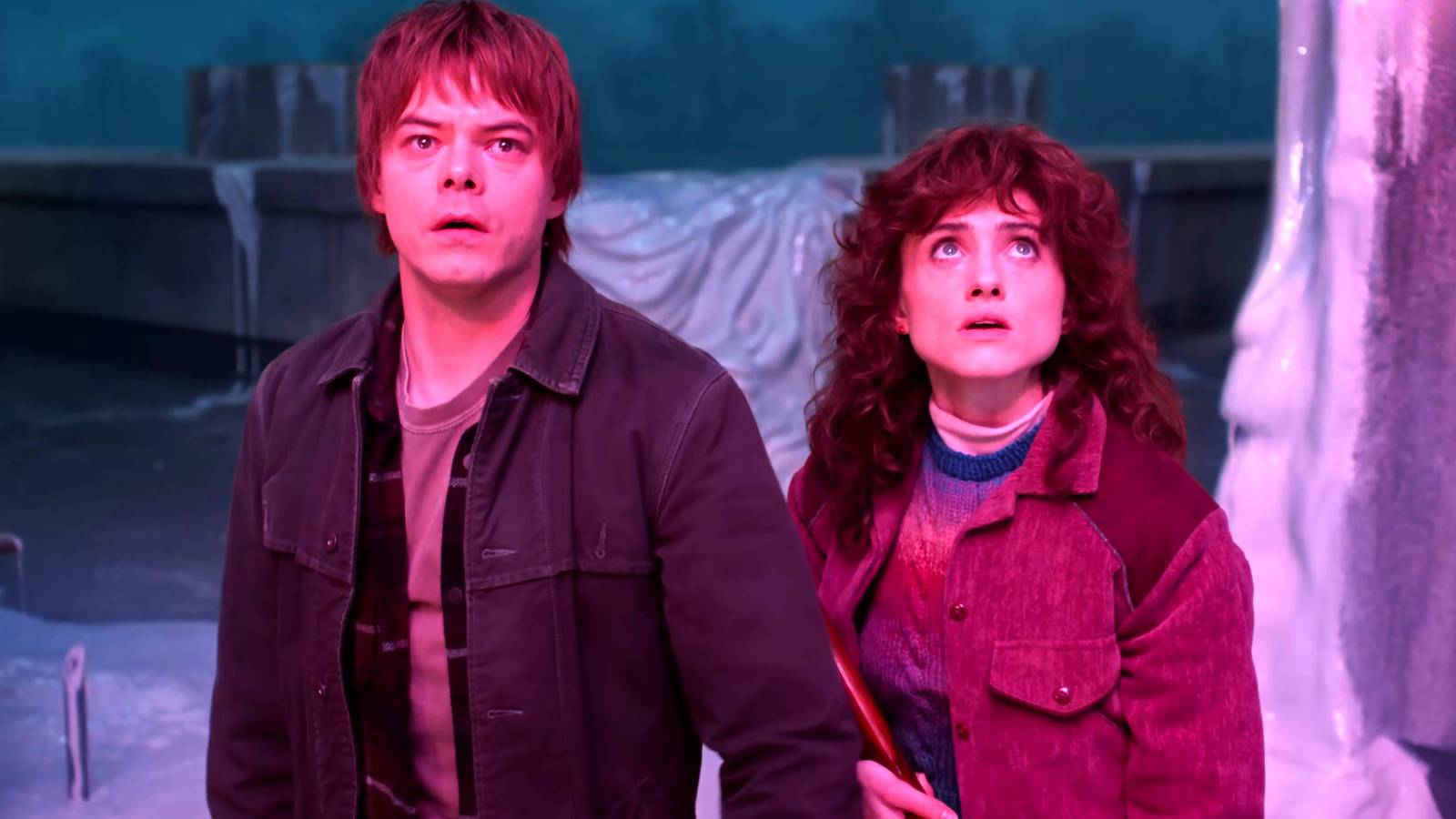 Charlie Heaton's Jonathon and Natalia Dyer's Nancy looking worried at something while in the Upside Down in Stranger Things season 5