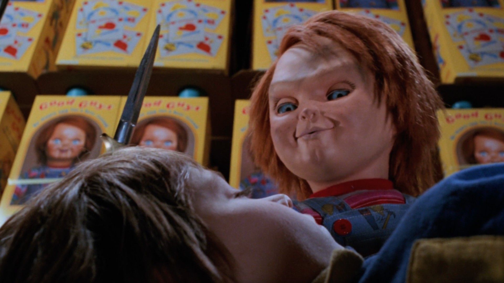 Chucky stands over Andy with a knife in Child's Play 2