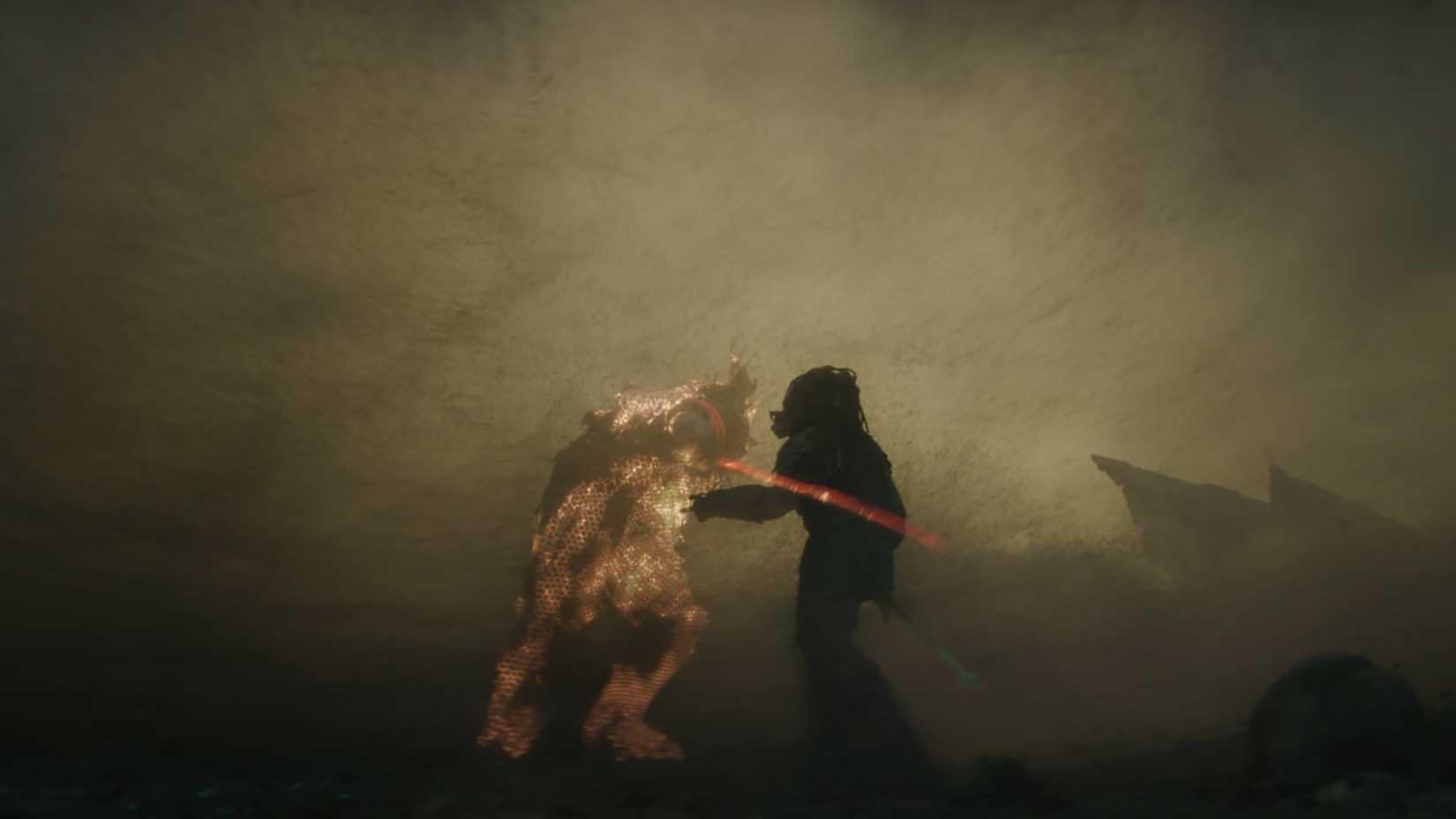Dek esfaqueando Njohrr no meio da tempestade de areia em Predator: Badlands