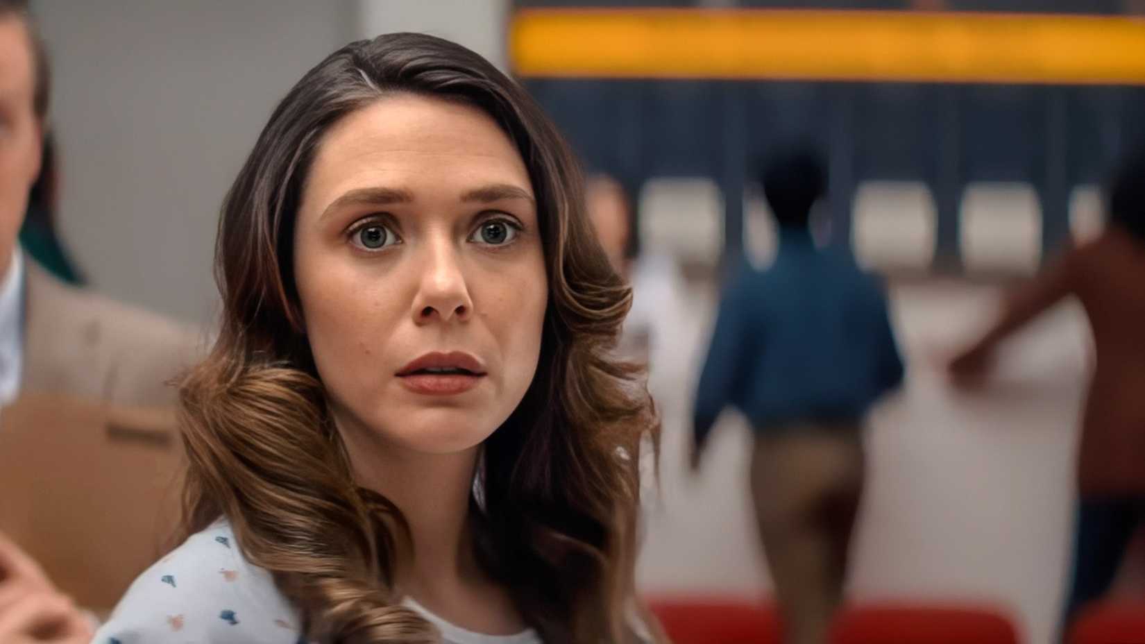 Elizabeth Olsen gazes forward with a look of trepidation in a scene from Eternity