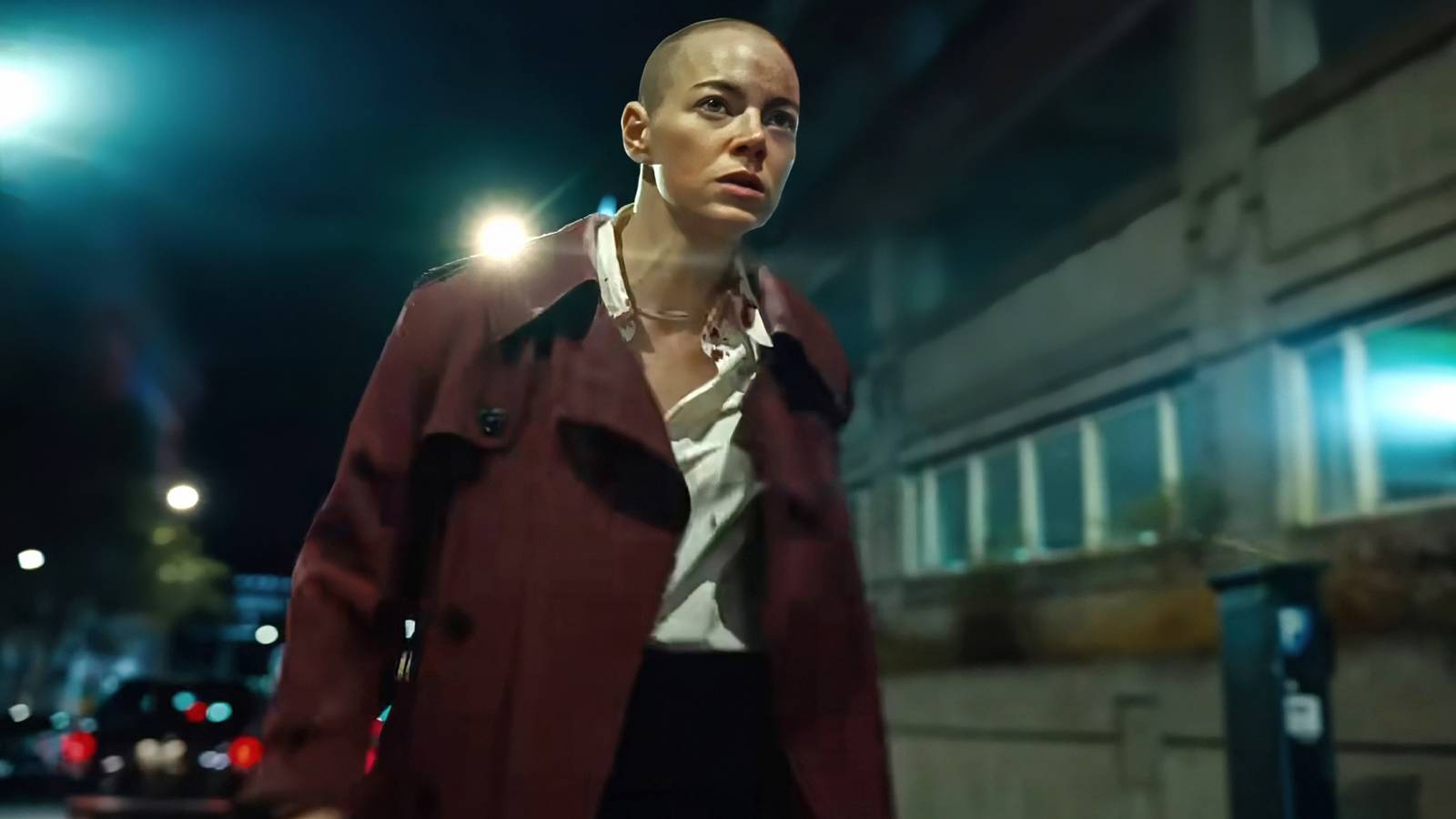 Emma Stone as Michelle walking down a street looking distraught in Bugonia