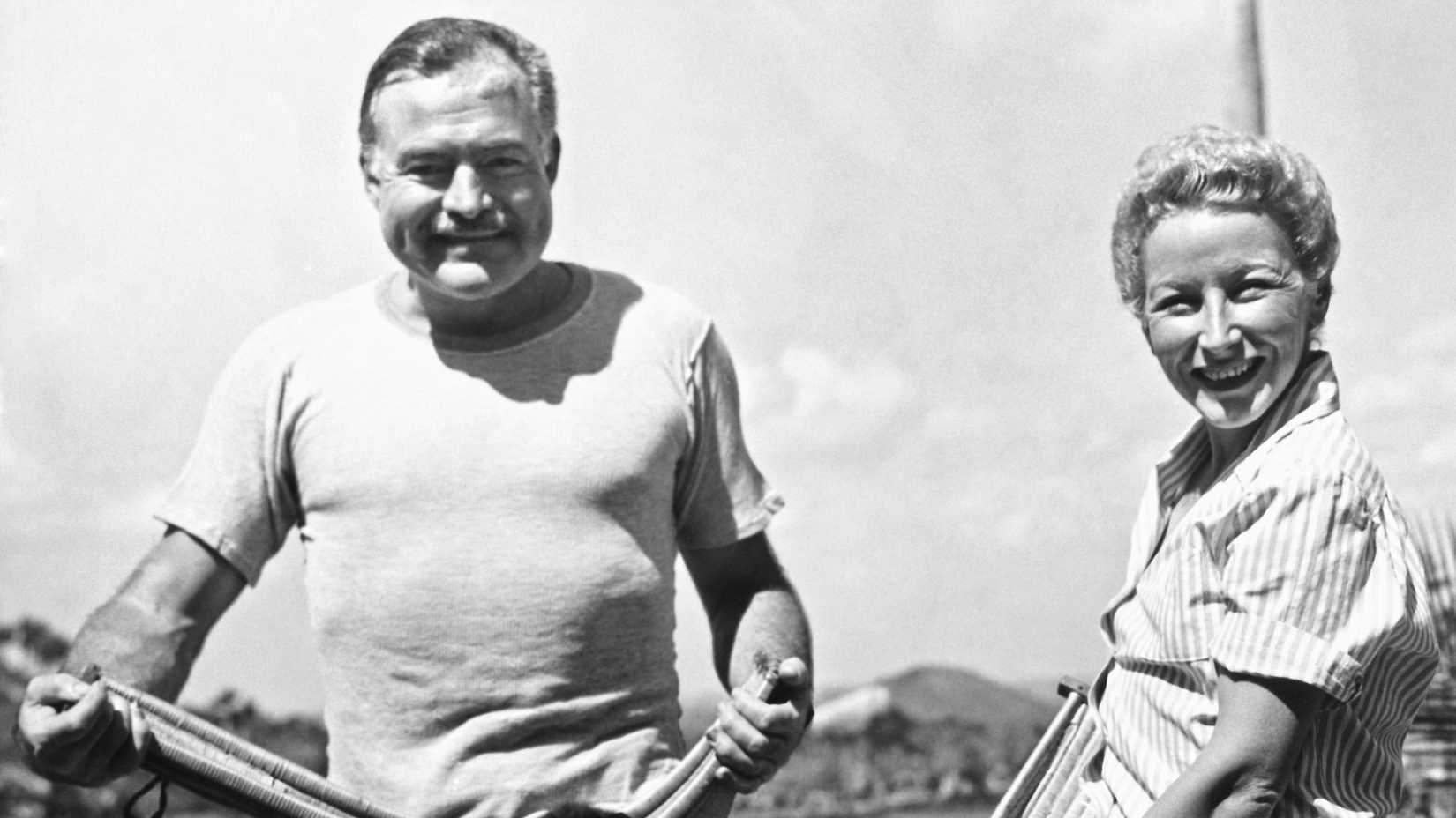 Author Ernest Hemingway and his fourth wife, Mary Welsh, hold their pets in jai alai baskets on the Hemingway farm in San Francisco de Paulo, a Havana suburb