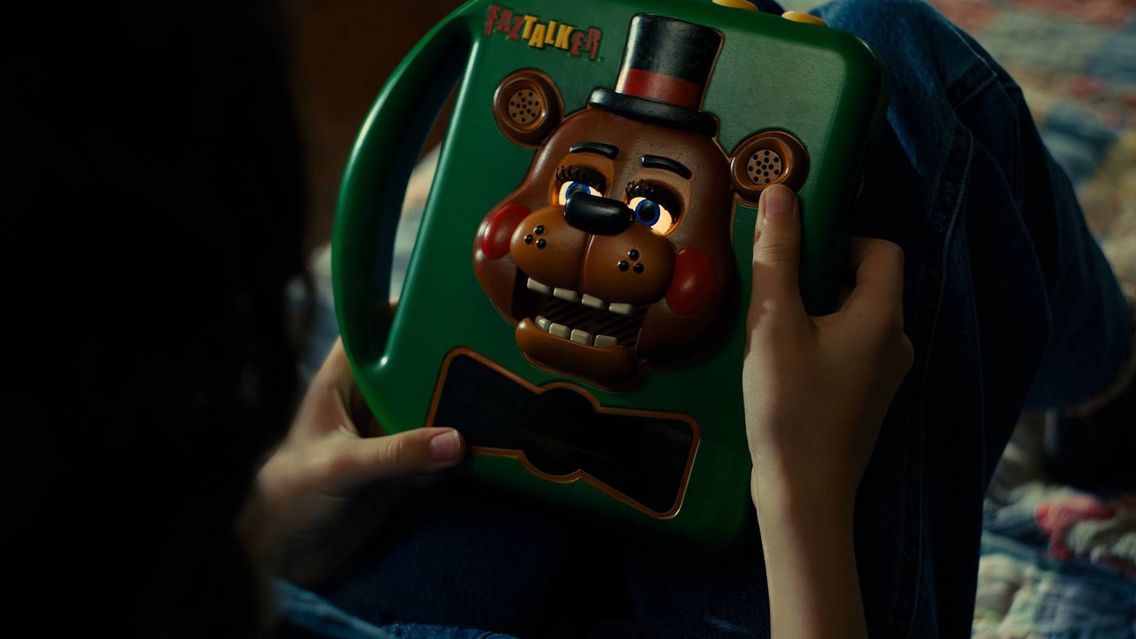 Abby holds a Freddy Fazbear speaking device in Five Nights at Freddy's 2