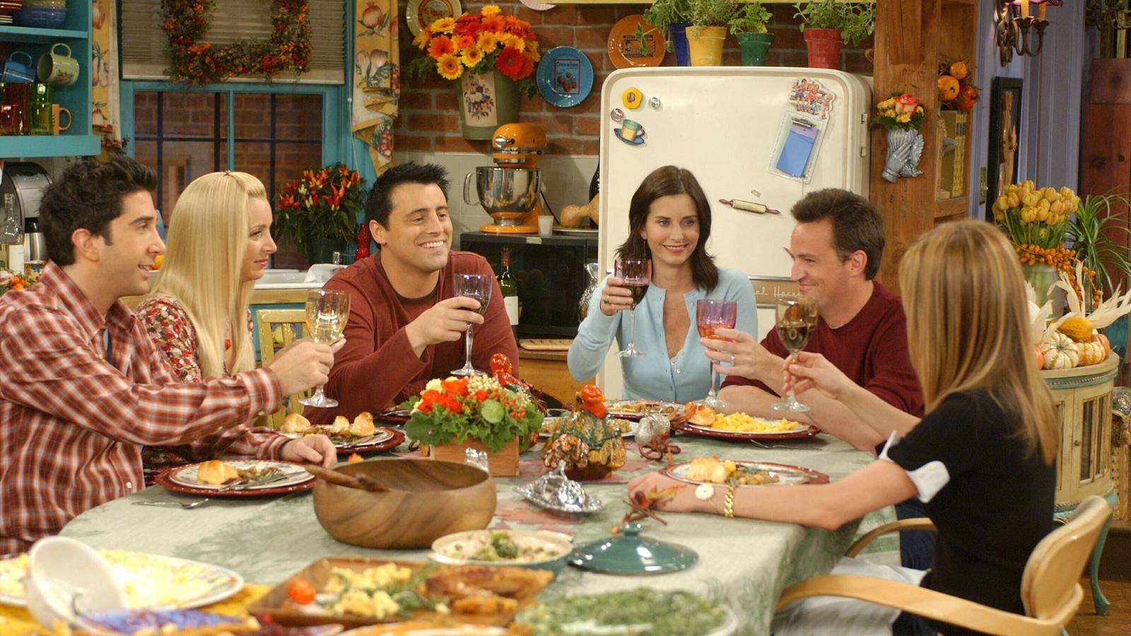 Monica and Rachel's apartment on Friends with the whole group giving a toast for Thanksgiving.