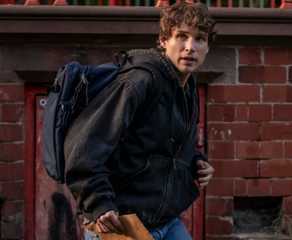 Guy carring an envelope and wearing a backpack in Talamasca The Secret Order