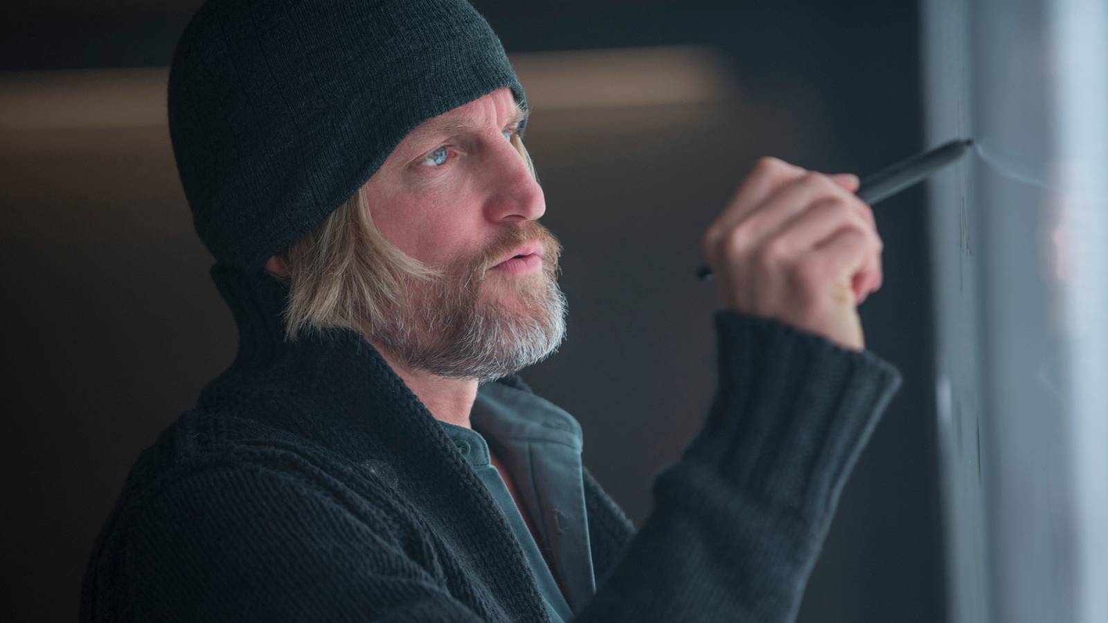 Haymitch drawing on a board in The Hunger Games