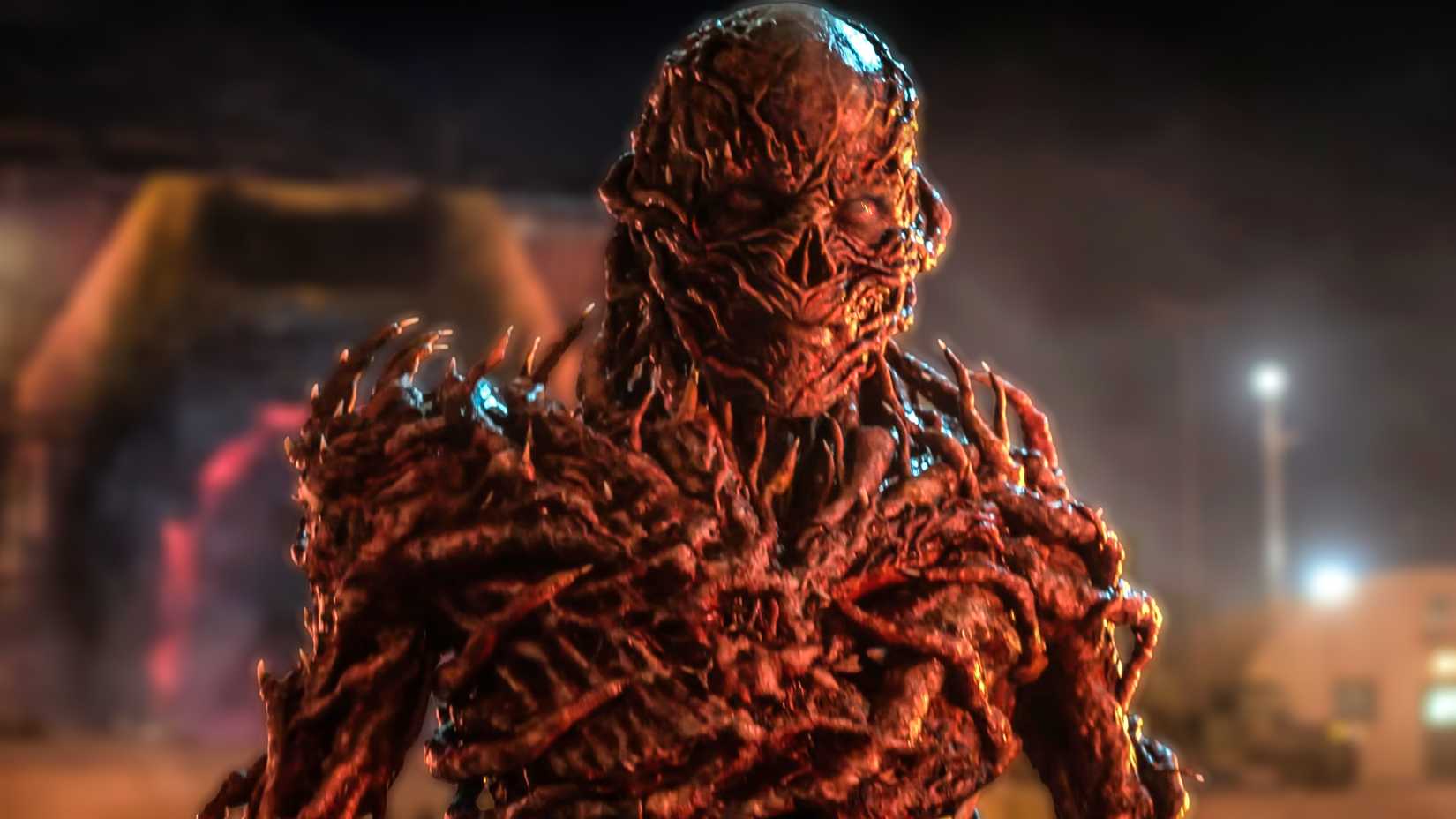 jamie campbell bower as vecna looking intensely while coming out of a portal in stranger things season 5