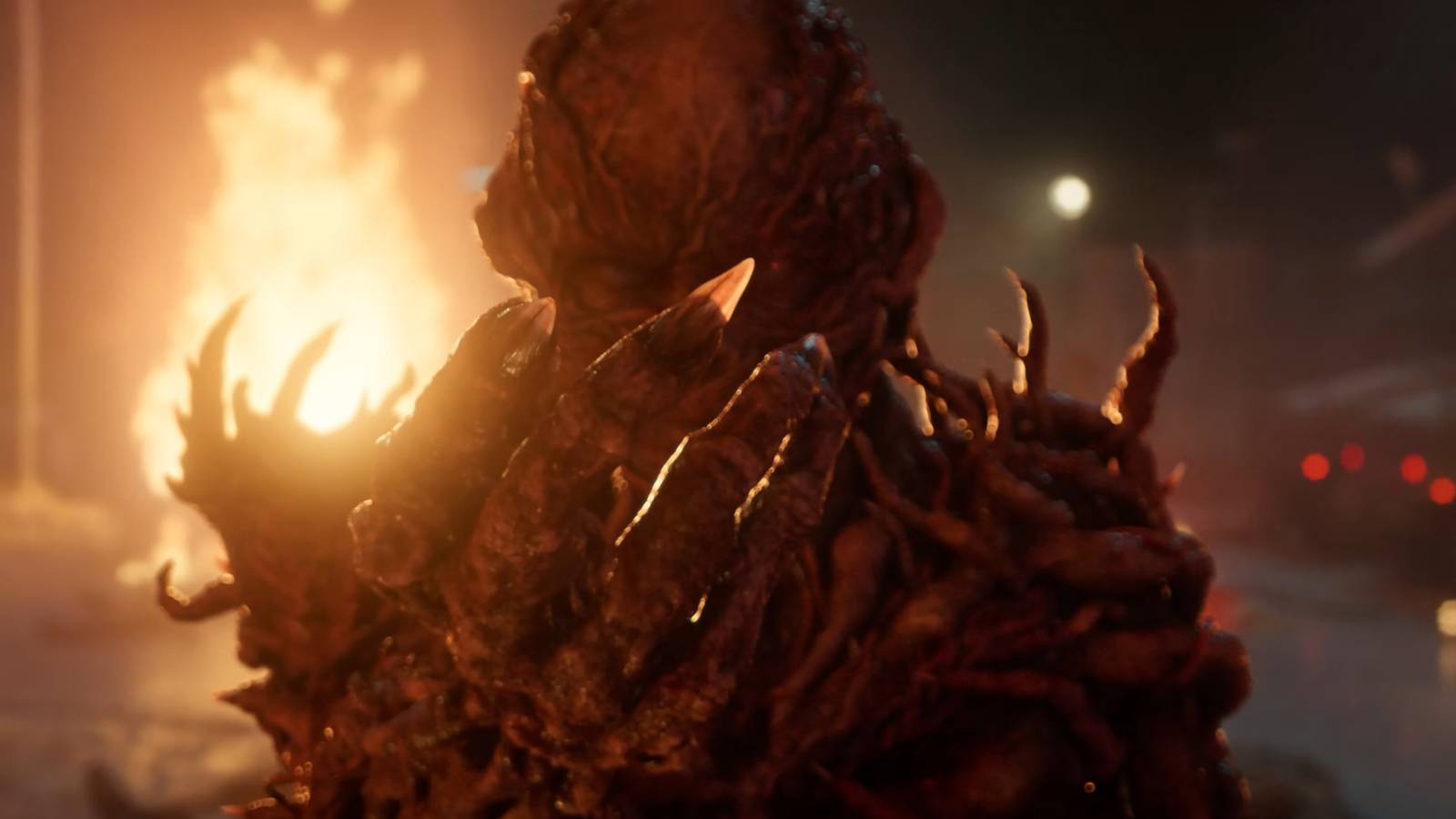 Jamie Campbell Bower's Vecna with his hand up while a fire is behind him in Stranger Things season 5