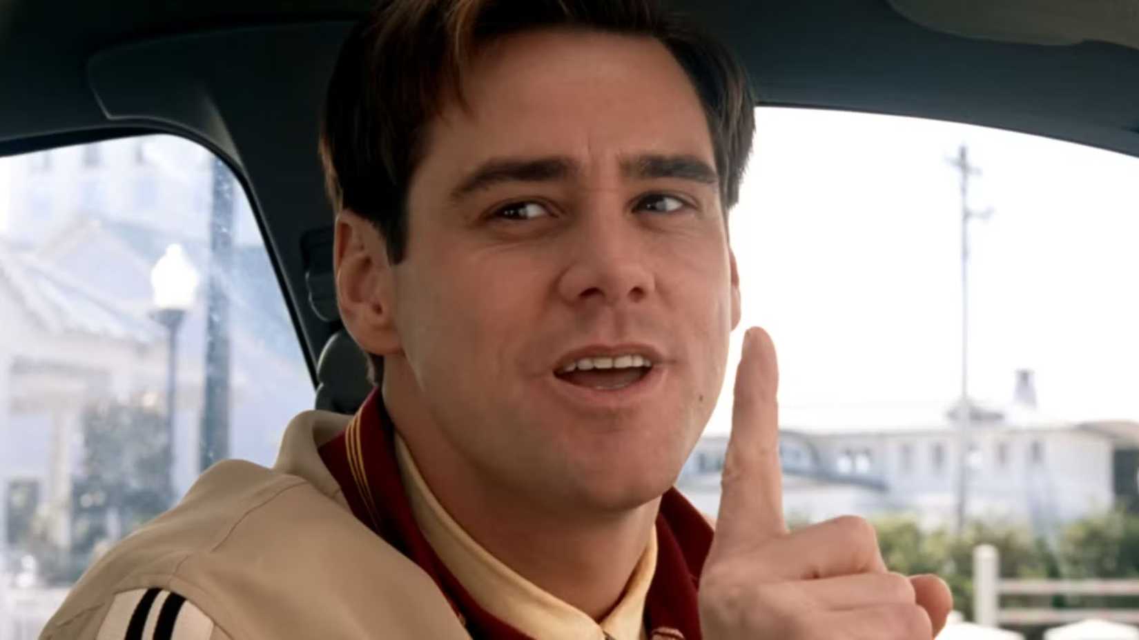 Jim Carrey como Truman levantando um dedo em The Truman Show